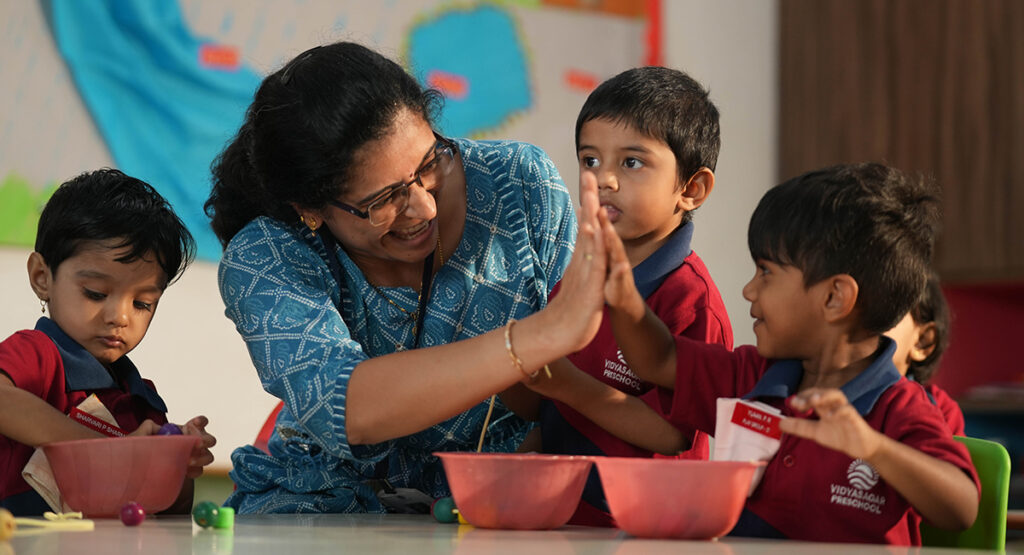 Teacher talking to student in class
